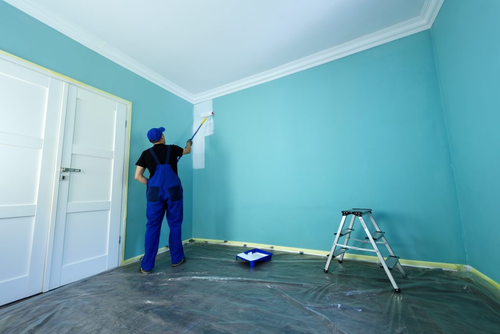 man painting, maintaining house