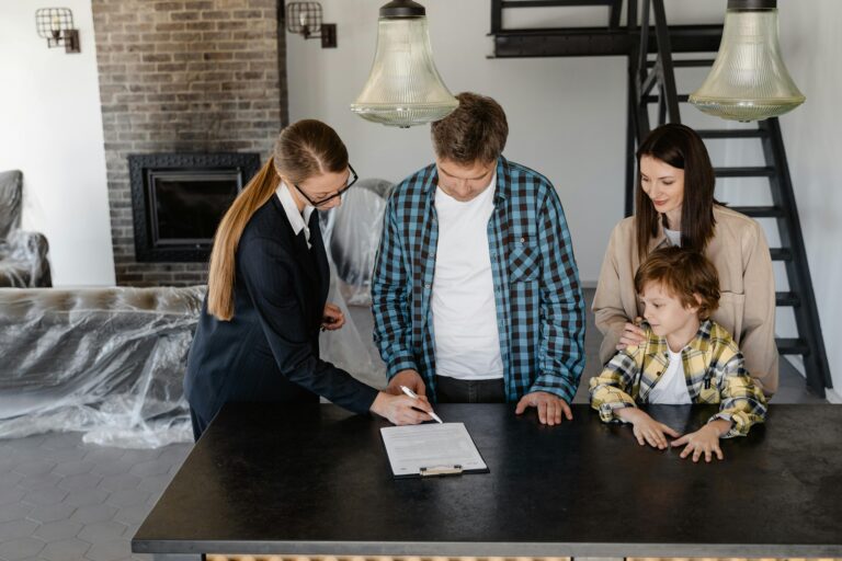 A property manager going over paperwork with a family of renters.