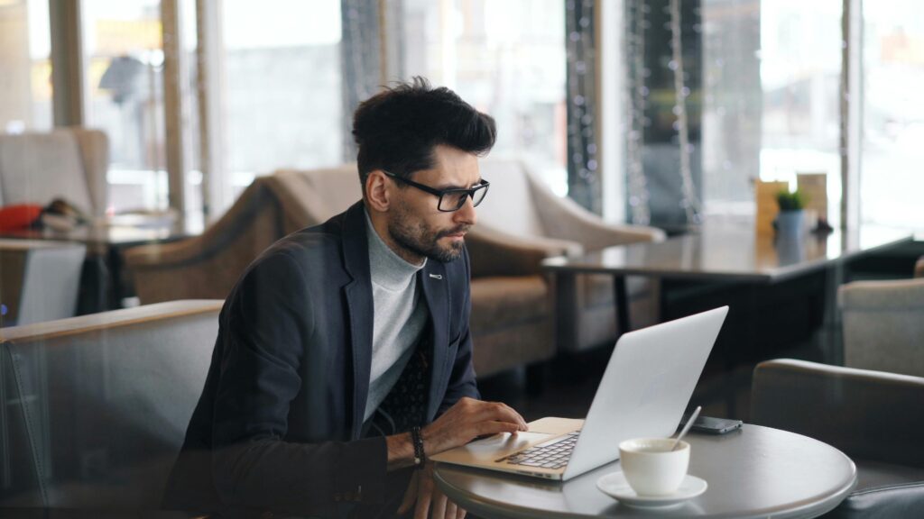 A Landlord Checks Financial Statements on Their Laptop