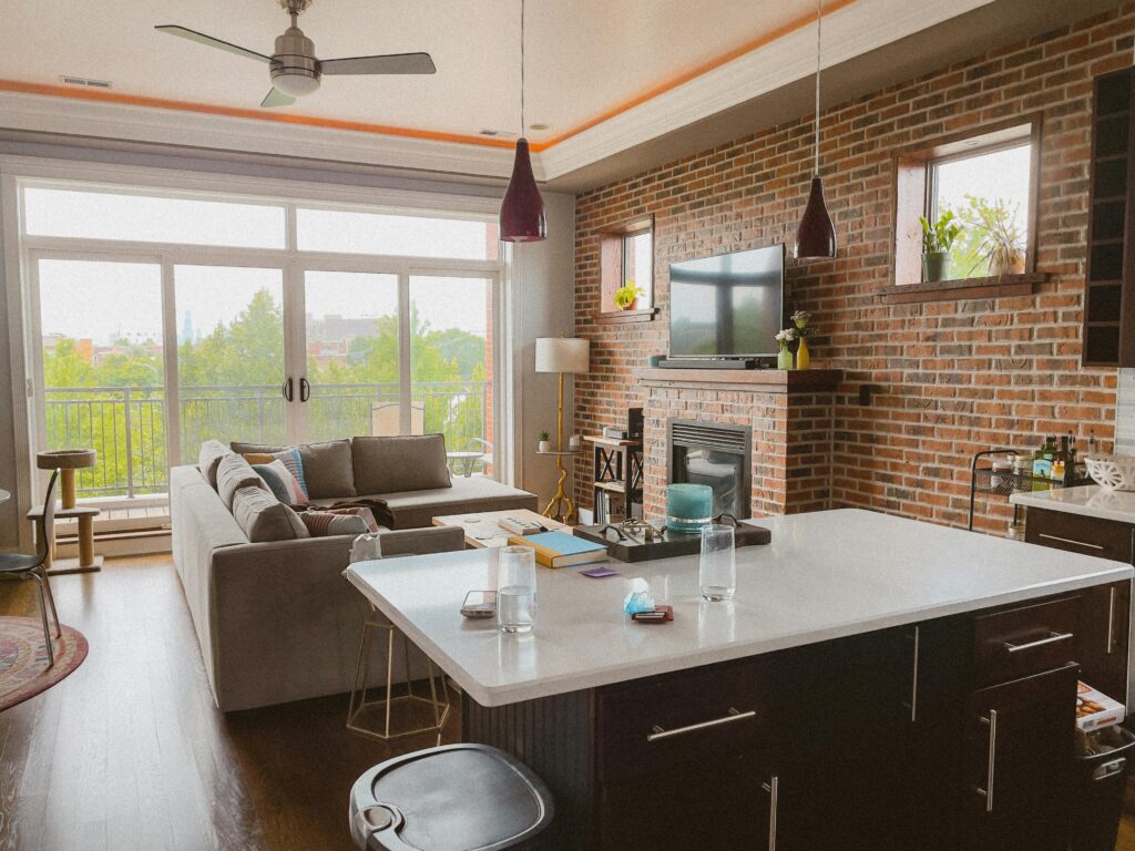 Apartment Interior with Dining Room and Exposed Brick Wall with Fireplace
