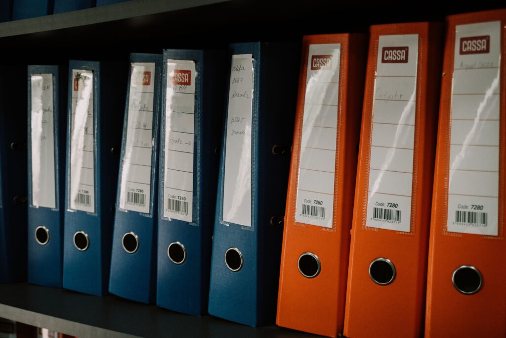Blue and Red Binders on a Shelf