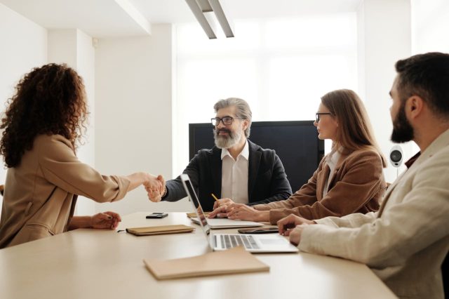 pexels-edmond-dantes-4344860 people shaking hands over a table